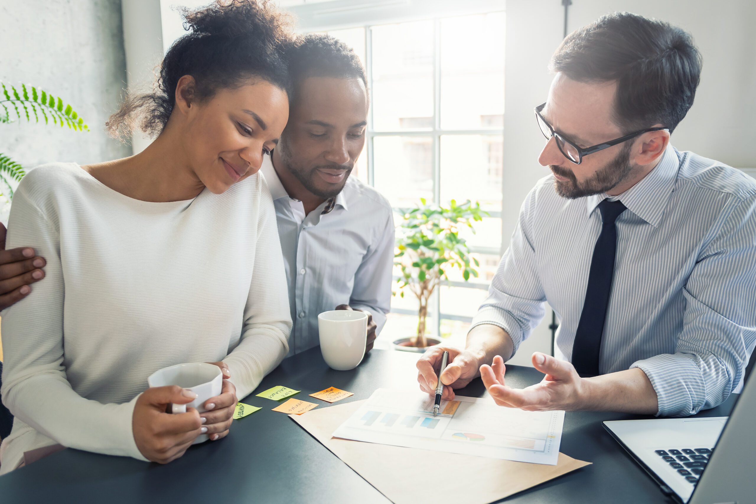 a young couple meeting with a financial advisor