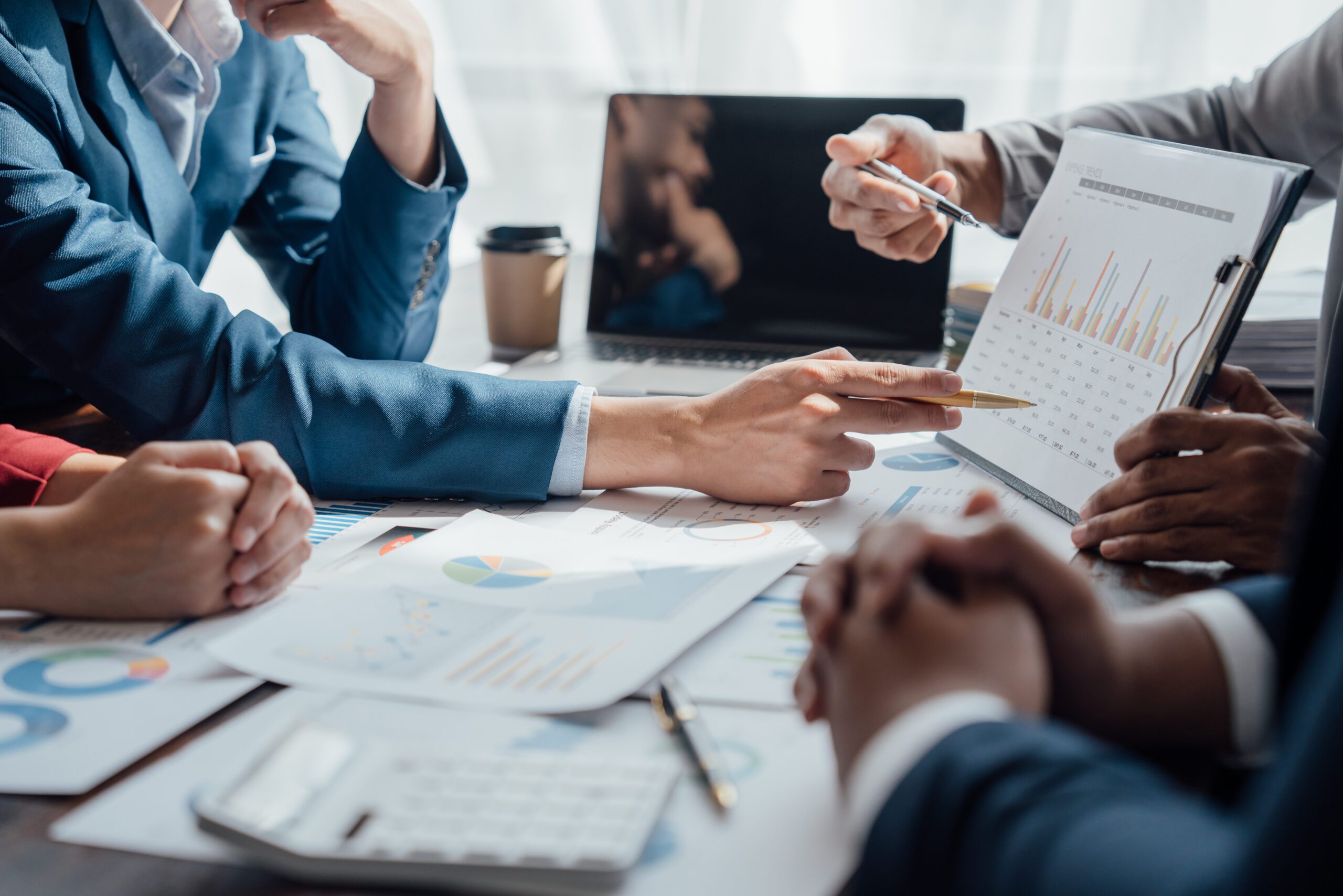 a group of professionals reviewing financial documents